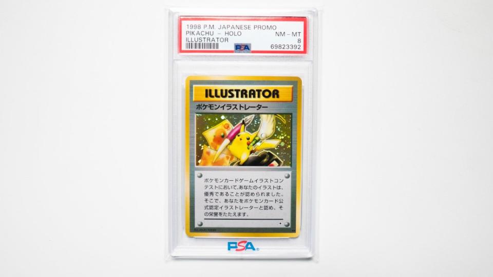 Pokémon collector Tomoya Ohno holds up a 1998 Pikachu Illustrator card PSA 8 card for sale