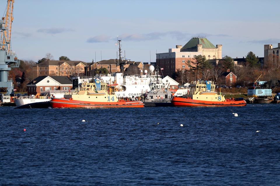 The USS Cheyenne submarine, flanked by tugboats, arrives at Portsmouth Naval Shipyard on Nov. 23, 2022.