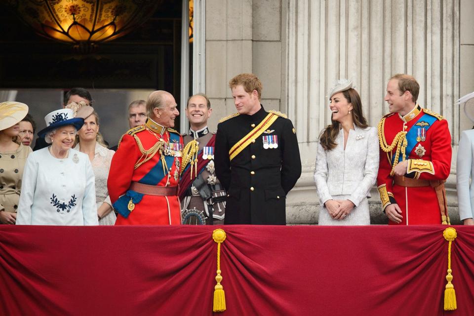 The Queen, the Duke of Edinburgh, Prince Harry, Kate Middleton and Prince William laugh together while watching the 2014 Trooping the Colour. 