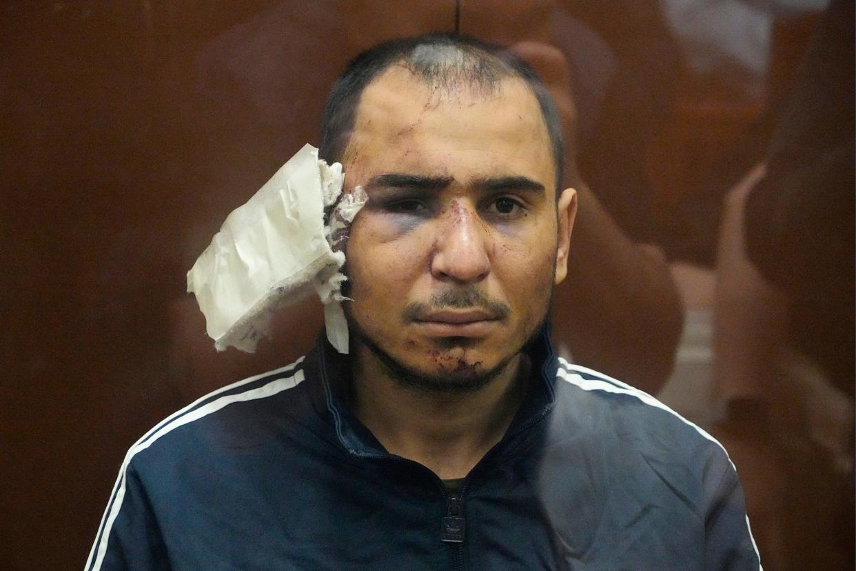 Saidakrami Murodali Rachabalizoda, a suspect in the Crocus City Hall shooting on Friday, sits in a glass cage in Moscow with a heavily bandaged right ear (AP)