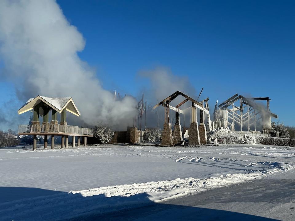 The remains of the Northern Bear Golf Course club house were still smoking Saturday afternoon after the structure caught fire earlier that morning.