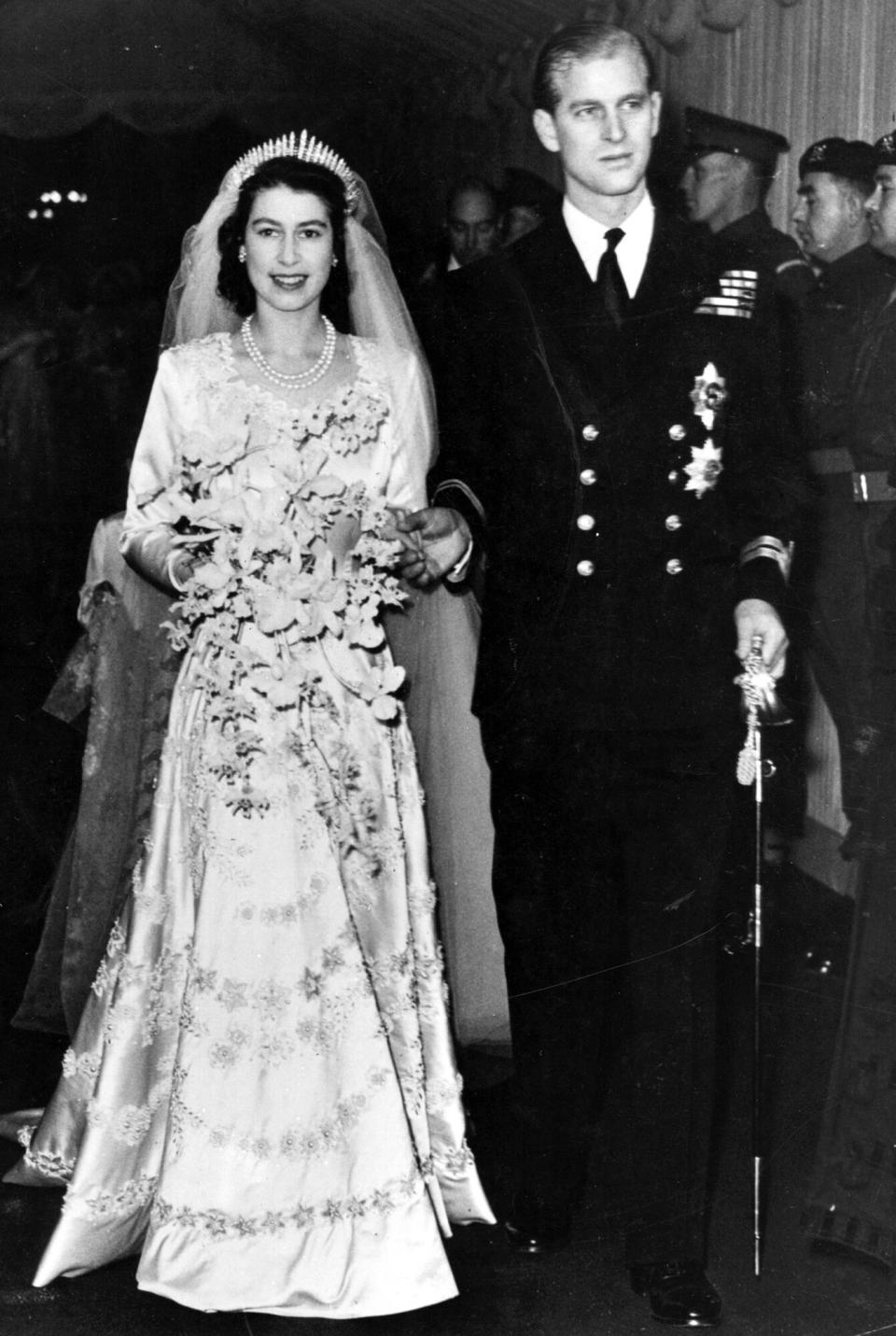 Queen Elizabeth II, as Princess Elizabeth, and her husband the Duke of Edinburgh, styled Prince Philip in 1957, on their wedding day. She became queen on her father King George VI's death in 1952