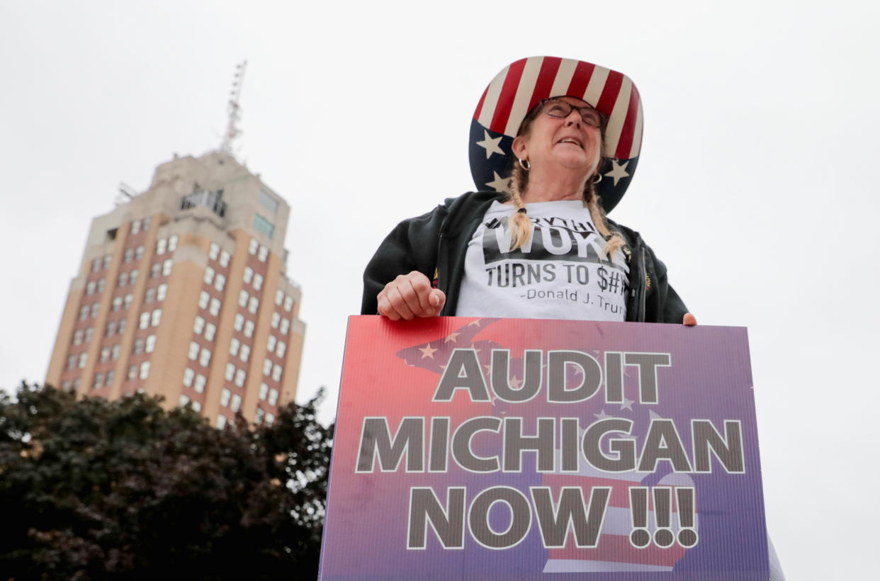 A supporter of former U.S. President Donald Trump holds a sign outside the Michigan State Capitol to demand an audit of 2020 election votes, in Lansing, Michigan, U.S. October 12, 2021. (Rebecca Cook/Reuters)