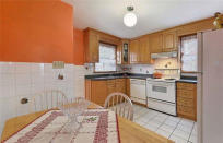 <p><span>146 Pitt Ave., Toronto, Ont.</span><br> The bright kitchen includes the fridge, stove and dishwasher.<br> (Photo: Zoocasa) </p>