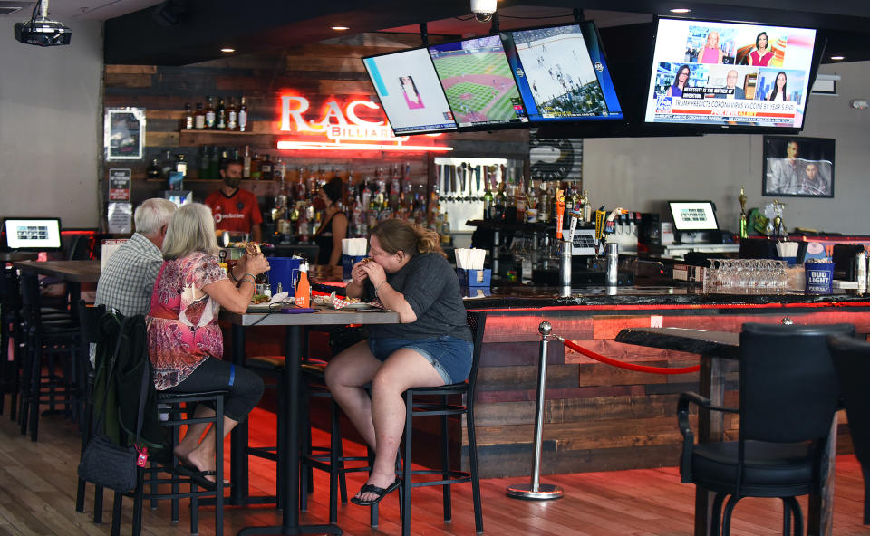 SANFORD, UNITED STATES - MAY 04, 2020: Customers enjoy a meal at Racks Billiards Sports Bar and Grill on the first day that retail stores and restaurants in all Florida counties except Palm Beach, Broward, and Miami Dade were permitted to reopen as COVID-19 restrictions are eased. Under phase one of the plan to reopen the state, stores and restaurants are limited to 25 percent of their indoor capacity.- PHOTOGRAPH BY Paul Hennessy / Echoes Wire/ Barcroft Studios / Future Publishing (Photo credit should read Paul Hennessy / Echoes Wire/Barcroft Media via Getty Images)