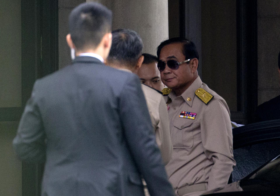 Thai Prime Minister Prayuth Chan-ocha, right, arrives at Government house in Bangkok, Thailand, Monday, March 26, 2019. A military-backed party has taken the lead in Thailand's first election since a 2014 coup, preliminary results showed, suggesting junta leader and Prime Minister Prayuth Chan-ocha could stay in power, helped by an electoral system tilted in the military's favor.(AP Photo/Sakchai Lalit)