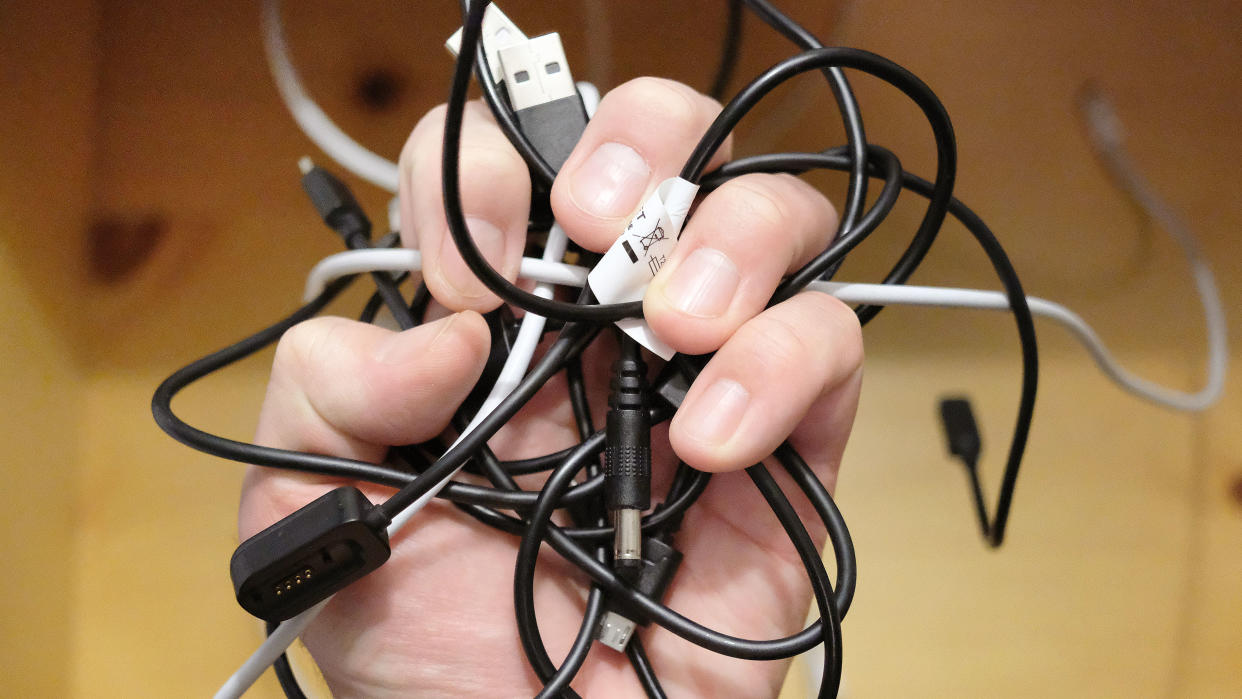  A hand full of random charging cables. 