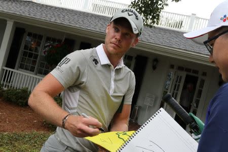 Danny Willett of England signs an autograph during Monday practice rounds for the 2017 Masters at Augusta National Golf Course in Augusta, Georgia, U.S., April 3, 2017. REUTERS/Jonathan Ernst