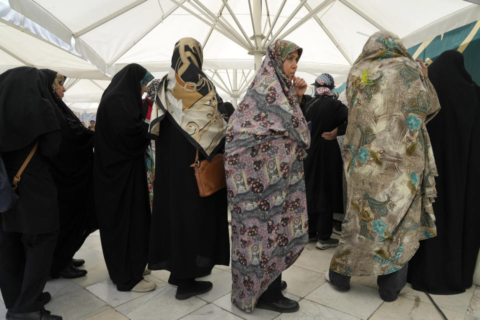 Iranian women line up to vote for the presidential election at a polling station at the shrine of Saint Saleh in northern Tehran, Iran, Friday, June 28, 2024. Iranians were voting Friday in a snap election to replace the late President Ebrahim Raisi, killed in a helicopter crash last month, as public apathy has become pervasive in the Islamic Republic after years of economic woes, mass protests and tensions in the Middle East. (AP Photo/Vahid Salemi)