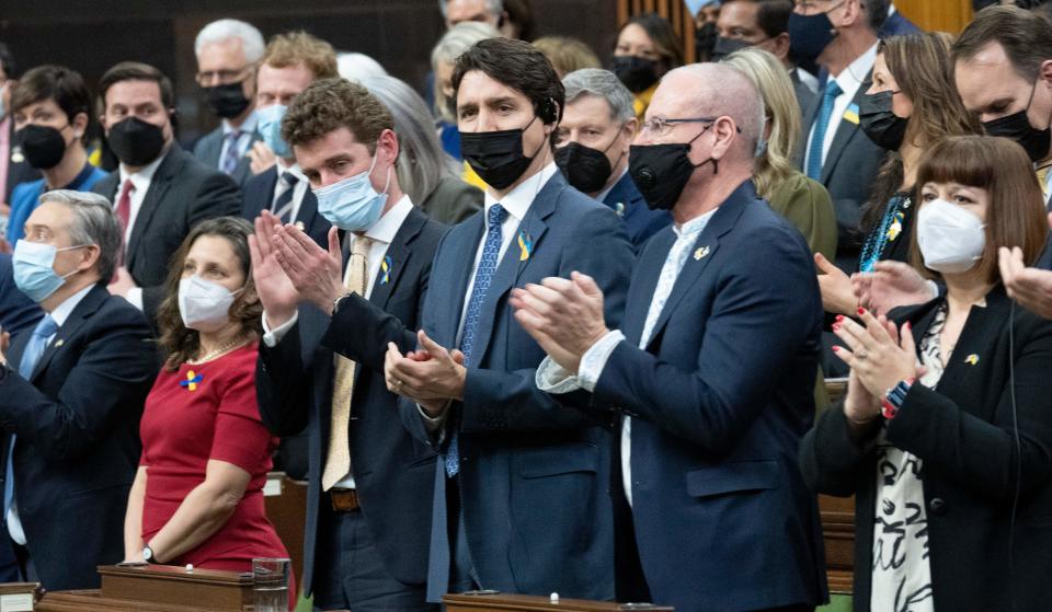 Canadian Prime Minister Justin Trudeau applauds with members of Parliament following Zelensky's virtual address.