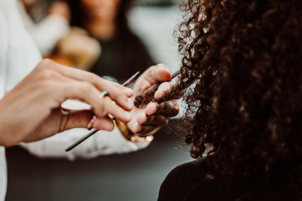 someone cutting curly hair