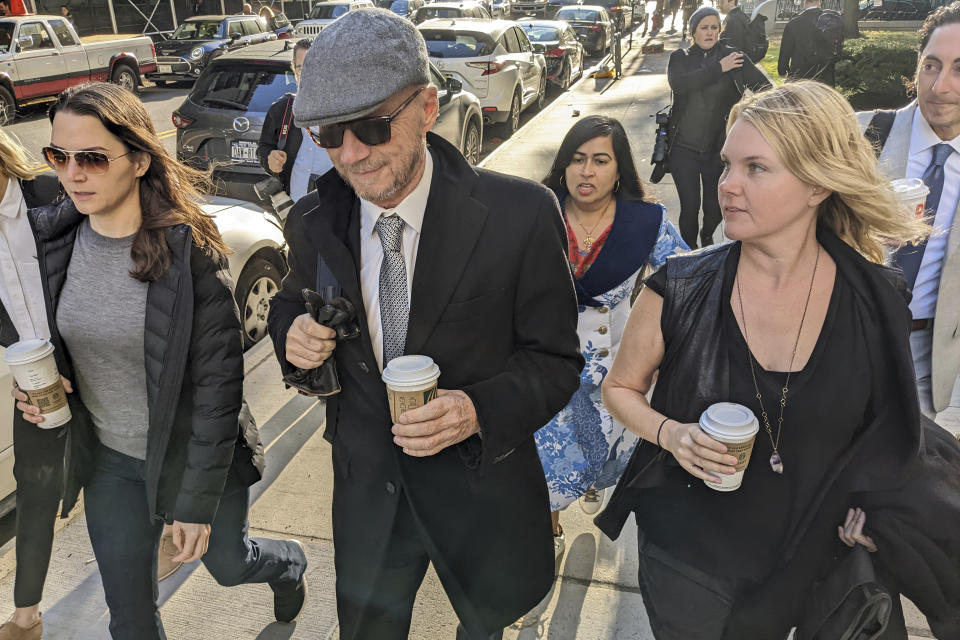 Film director Paul Haggis, center, arrives at court on Wednesday, Oct. 19, 2022, in the Manhattan borough of New York. Jurors are getting their first look at a lawsuit that pits Oscar-winning moviemaker Haggis against a publicist who alleges that he raped her. He says their 2013 encounter was consensual. (AP Photo/Ted Shaffrey)