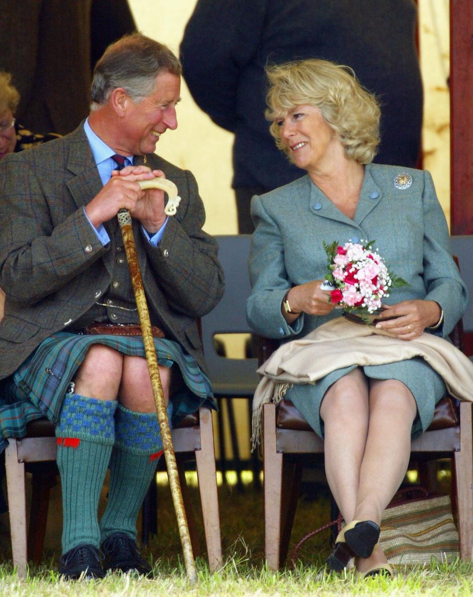King Charles III and Camilla Parker look at each other.