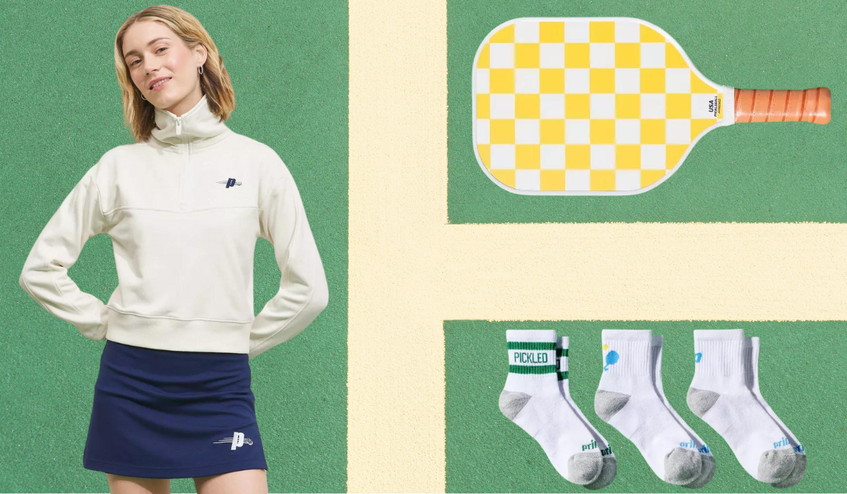 woman wearing white pullover and blue skirt, yellow and white checked pickleball paddle, and 3 pairs of white ankle socks