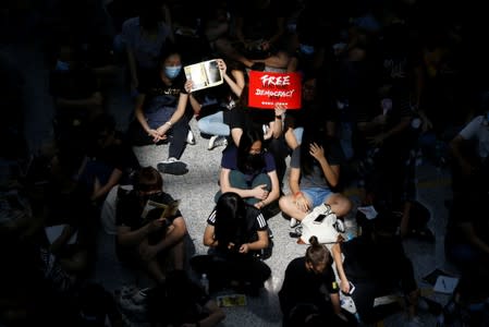 Anti-extradition bill demonstrators attend a protest at the arrival hall of Hong Kong Airport