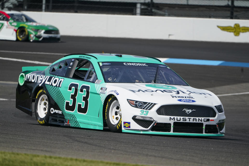 Austin Cindric (33) drives through a turn during practice for the NASCAR Cup Series auto race at Indianapolis Motor Speedway in Indianapolis, Saturday, Aug. 14, 2021. (AP Photo/Michael Conroy)