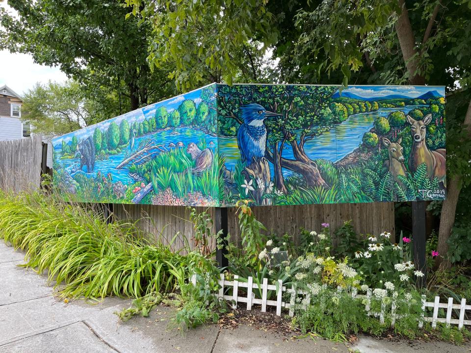 "The River Dwellers" by T. Ariel Goreau sits at the corner of Chase Street and Barrett Street in the Old East End. The whimsical mural features animals in their natural habitats and trees with faces.