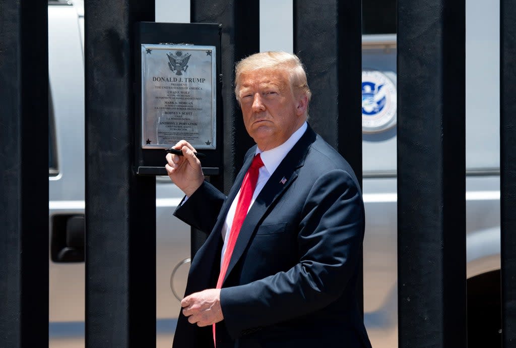 TOPSHOT - US President Donald Trump looks on before signing a plaque as he participates in a ceremony commemorating the 200th mile of border wall at the international border with Mexico in San Luis, Arizona, June 23, 2020. (Photo by SAUL LOEB / AFP) (Photo by SAUL LOEB/AFP via Getty Images) (AFP via Getty Images)