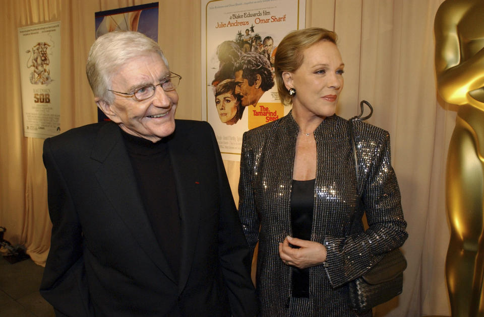 FILE - This Feb. 26, 2004 file photo shows director Blake Edwards, left, and his wife Julie Andrews as they arrive for a special reception for Edwards, who will receive an Honorary Oscar at the 76th Academy Awards ceremony, in the Hollywood section of Los Angeles. Andrews released a memoir, “Home Work: A Memoir of My Hollywood Years,” which hits shelves on Oct. 15, 2019. (AP Photo/Rene Macura, File)