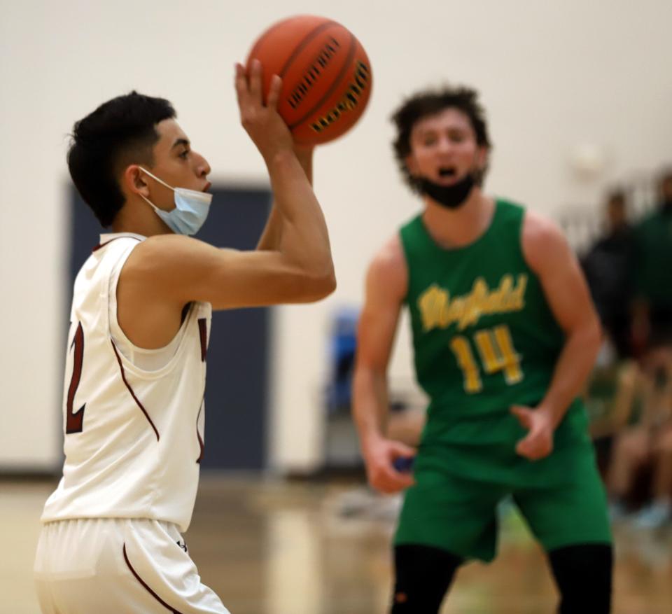 Junior Wildcat Cesar Ramirez spotted up and nailed two 3-pointers in Deming's 74-54 loss to the Mayfield High Trojans on Friday. Ramirez finished with 12 points.