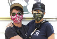 In this Sept. 2020 photo, Crisis Worker Emergency Medical Technician (EMT), Sara Stroo, left, and Crisis Worker Laurel Lisovskis with CAHOOTS, a mental health crisis intervention program, take a moment before heading out on an evening shift in Eugene, Ore. When police respond to a person gripped by a mental health or drug crisis, the encounter can have tragic results. Now a government health program will help communities set up an alternative: mobile teams of practitioners trained in de-escalating such potentially volatile situations. (William Holderfield via AP)