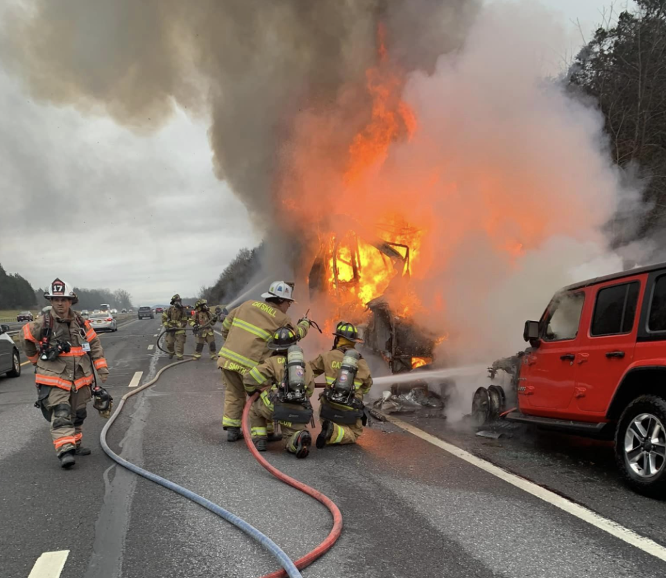 Firefighters work to put out a fire engulfing a crashed motorhome off a highway in Catskill, New York. / Credit: Catskill Fire Company