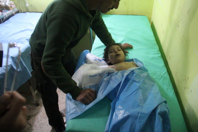An unconscious Syrian child receives treatment at a hospital in Khan Sheikhun, a rebel-held town in the Syrian Idlib province, following a suspected toxic gas attack on April 4, 2017. File Photo by Omar Haj Kadour/UPI