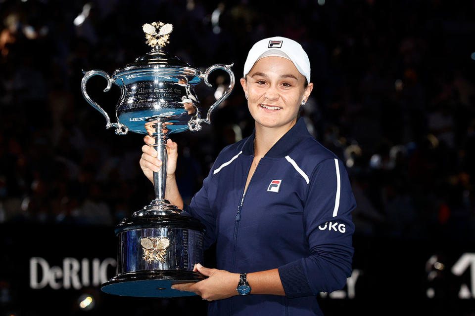 Ash Barty holding up a tennis trophy