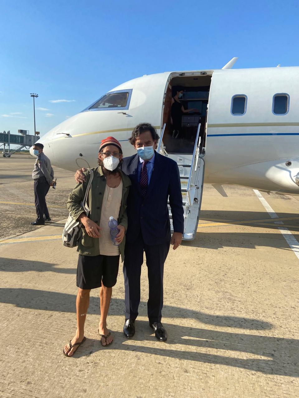 In this photo provided by the Richardson Center, former U.S. Ambassador to the U.N. Bill Richardson, right, poses with journalist Danny Fenster in Naypyitaw, Myanmar, Monday, Nov. 15, 2021. Richardson said in a statement Monday that Fenster had been released from prison and handed over to him in Myanmar and would be soon on his way home via Qatar.