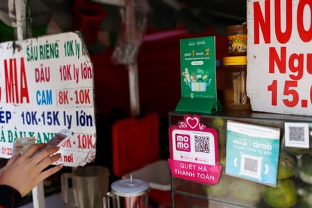 Mobile e-payment logos are seen at a street food stall in Ho Chi Minh city in Vietnam