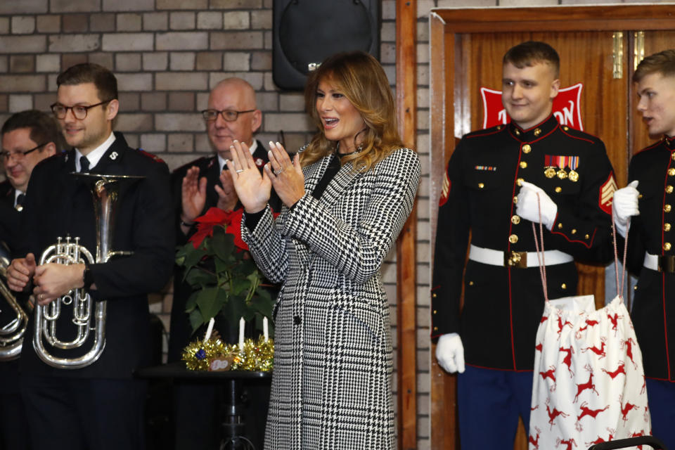 First lady Melania Trump applauds a children choir after joining local students and U.S. Marines stationed at the U.S. Embassy, wrapping holiday presents to be donated to the Salvation Army, at the Salvation Army Clapton Center in London, Wednesday, Dec. 4, 2019. (AP Photo/Alastair Grant, Pool)