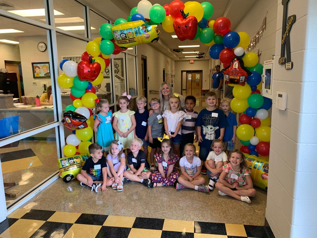 Participants in United Way's Kinder Camp at Glencoe Elementary School standing under a balloon arch set up by their new teachers.