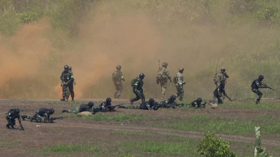 U.S. and Indonesian soldiers take their positions during Super Garuda Shield 2022 joint military exercises in Baturaja, South Sumatra, Indonesia, Friday, Aug. 12, 2022. The United States and Indonesian militaries conducted the annual combat exercises on Indonesia's Sumatra island, joined for the first time by participants from other partner nations including Australia, Japan and Singapore, signaling stronger ties amid growing maritime activity by China in the Indo-Pacific region. (AP Photo/Dita Alangkara)