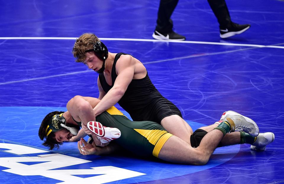 Shane Griffith (top) shown in the 2021 NCAA Tournament while wrestling for Stanford, concluded his career by finishing third at 174 pounds in the NCAA Tournament in Kansas City.