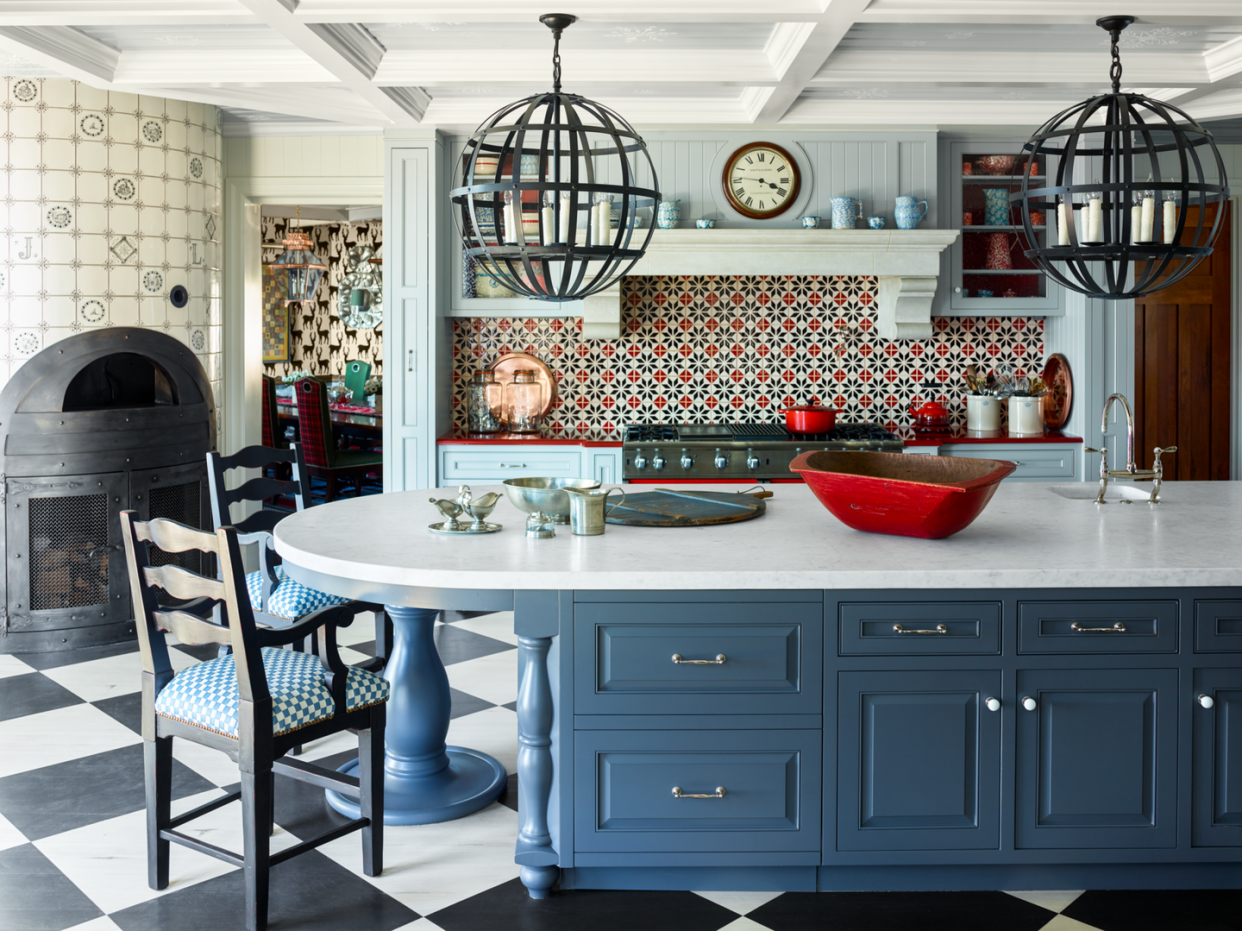 a blue and white kitchen with a quilt like backsplash