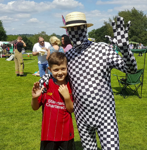 The mime artist posed for photos with the locals at the fete. (SWNS)