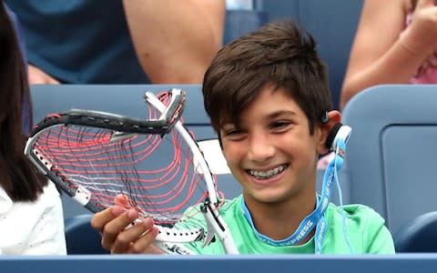 A young supporter recieves a broken raquet from Dominic Thiem of Austria during hie men's singles third round match against Taylor Fritz of the United States on Day Five of the 2018 US Open at the USTA Billie Jean King National Tennis Center on August 31, 2018 in the Flushing neighborhood of the Queens borough of New York City - Credit: Getty images