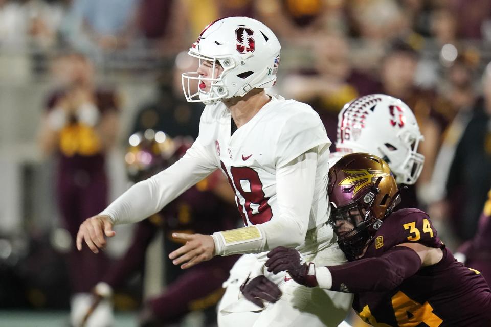 Arizona State linebacker Kyle Soelle (34) hits Tanner McKee, left, as he releases the ball during the second half of an NCAA college football game Friday, Oct. 8, 2021, in Tempe, Ariz. (AP Photo/Ross D. Franklin)