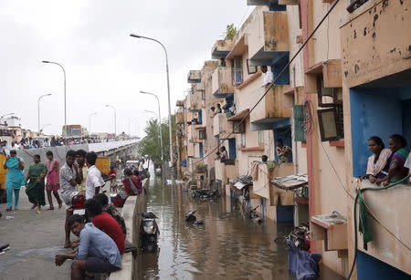 Residents watch from their partially flooded houses at a neighbourhood in Chennai, India, December 3, 2015. REUTERS/Anindito Mukherjee