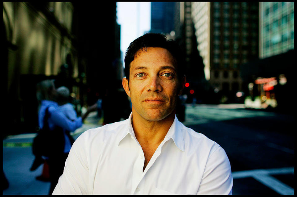 Jordan Belfort in a button-down with the city of New York behind him