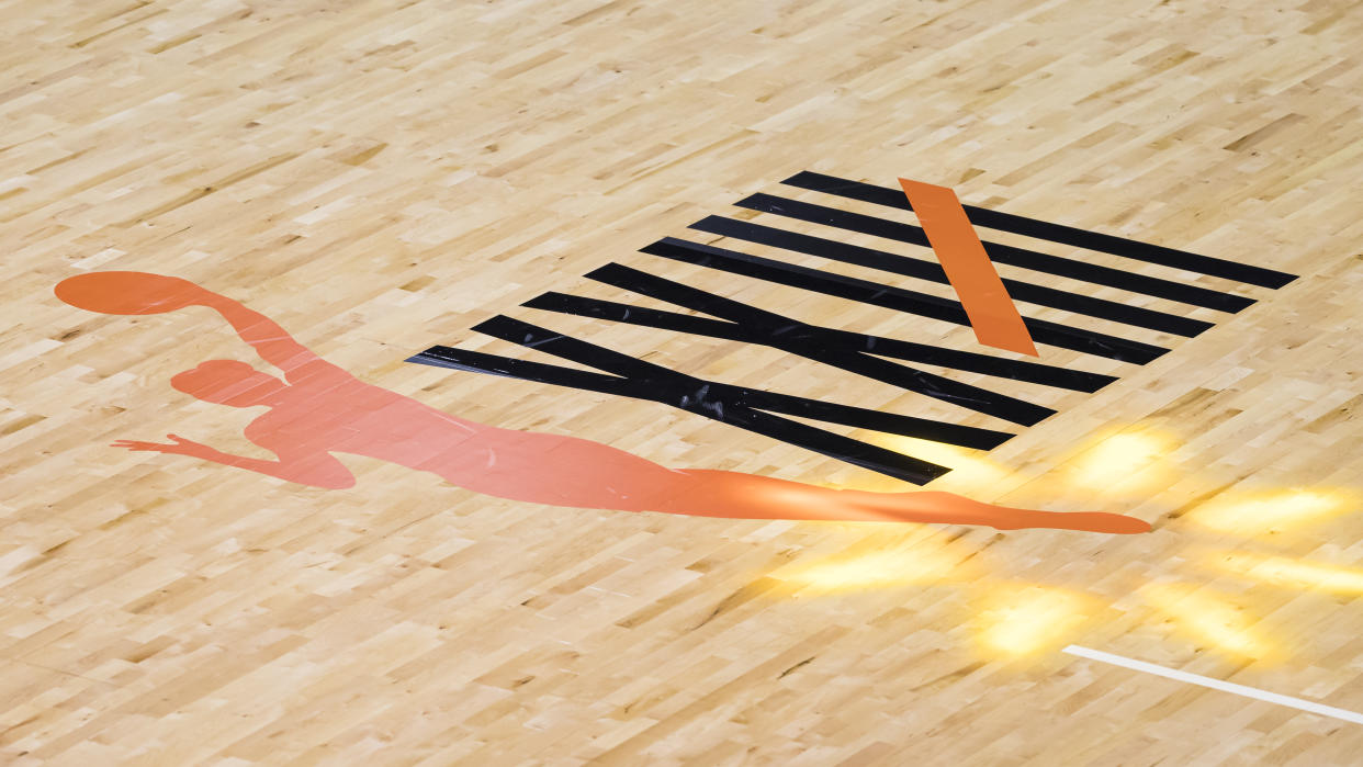 WNBA logo on the court.