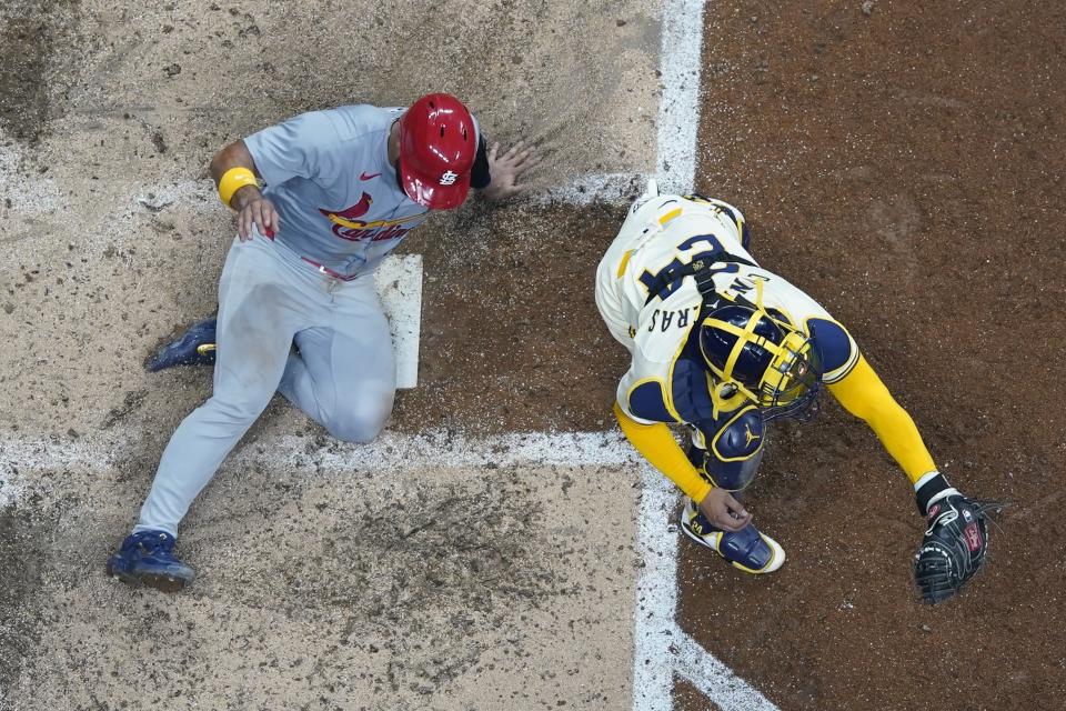 St. Louis Cardinals' Iván Herrera scores past Milwaukee Brewers catcher William Contreras during the seventh inning of a baseball game Friday, May 10, 2024, in Milwaukee. (AP Photo/Morry Gash)