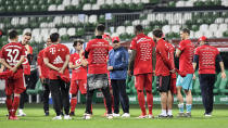 Bayern's head coach Hansi Flick, center, talks to his players after winning the German Bundesliga soccer match between Werder Bremen and Bayern Munich in Bremen, Germany, Tuesday, June 16, 2020. Bayern became champion for the 30th time in Germany. Because of the coronavirus outbreak all soccer matches of the German Bundesliga take place without spectators. (AP Photo/Martin Meissner, Pool)