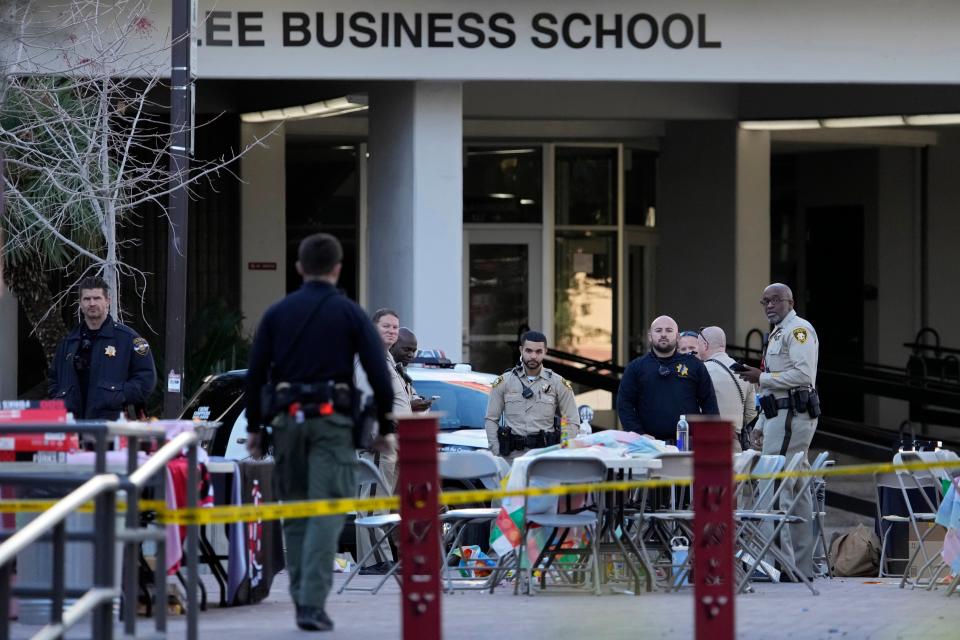 Las Vegas police stand near the scene of a shooting at the University of Nevada (AP)