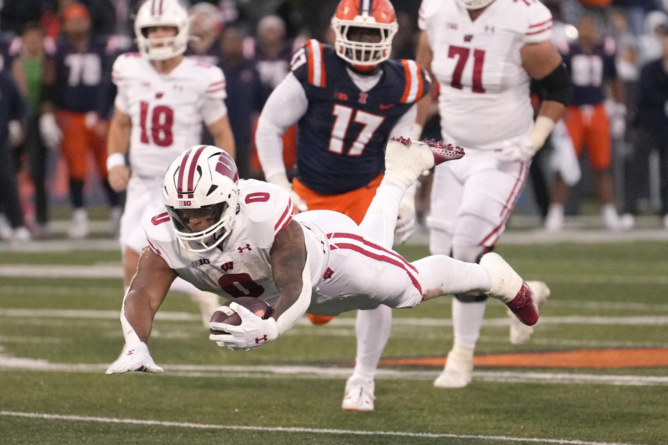 Wisconsin running back Braelon Allen dives for extra yardage late in the second half of an NCAA college football game against Illinois, Saturday, Oct. 21, 2023, in Champaign, Ill. (AP Photo/Charles Rex Arbogast)