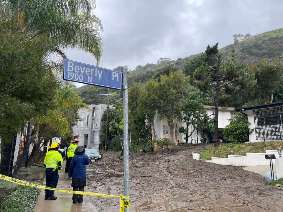 Firefighters at the scene of the slide on Tuesday (Mike Bedigan/ The Independent)