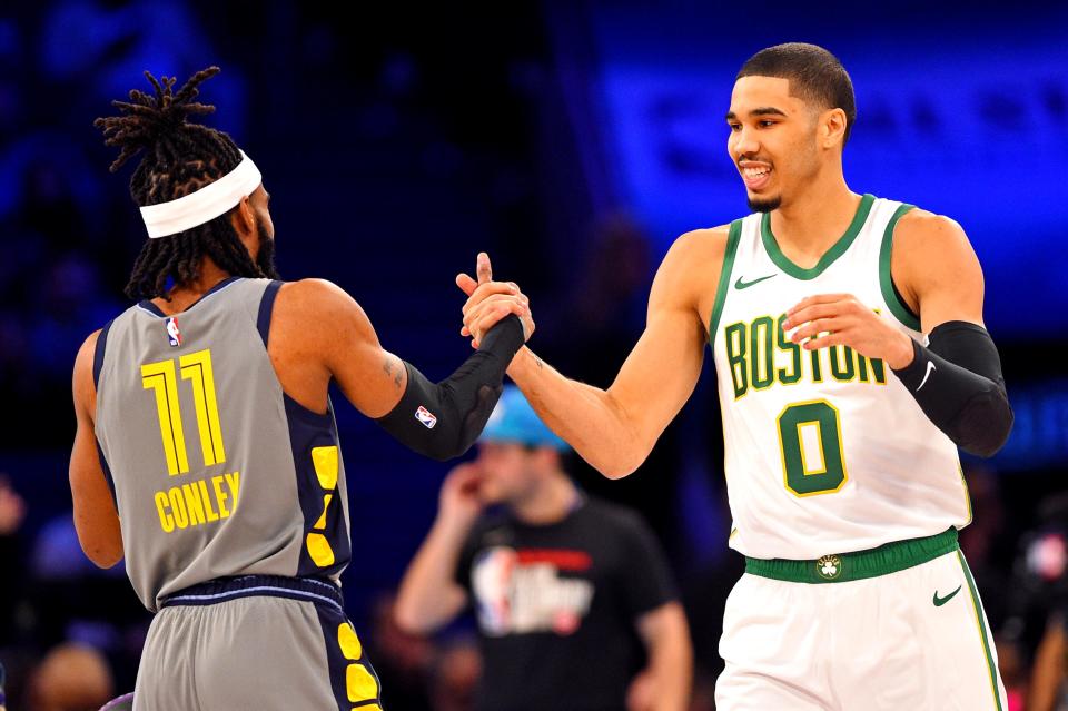 Feb 16, 2019; Charlotte, NC, USA; Memphis Grizzlies guard Mike Conley and Boston Celtics forward Jayson Tatum greet each other in the Skills Challenge during the NBA All-Star Saturday Night at Spectrum Center. Mandatory Credit: Bob Donnan-USA TODAY Sports