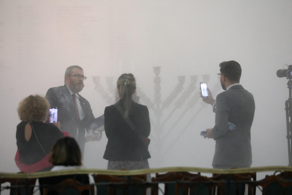 Grzegorz Braun, a far-right Polish lawmaker, second from the left, is seen after using a fire extinguisher to put out Hanukkah candles at the parliament in Warsaw, Poland Dec. 12, 2023. / Credit: Slawomir Kaminski/Agencja Wyborcza.pl/REUTERS