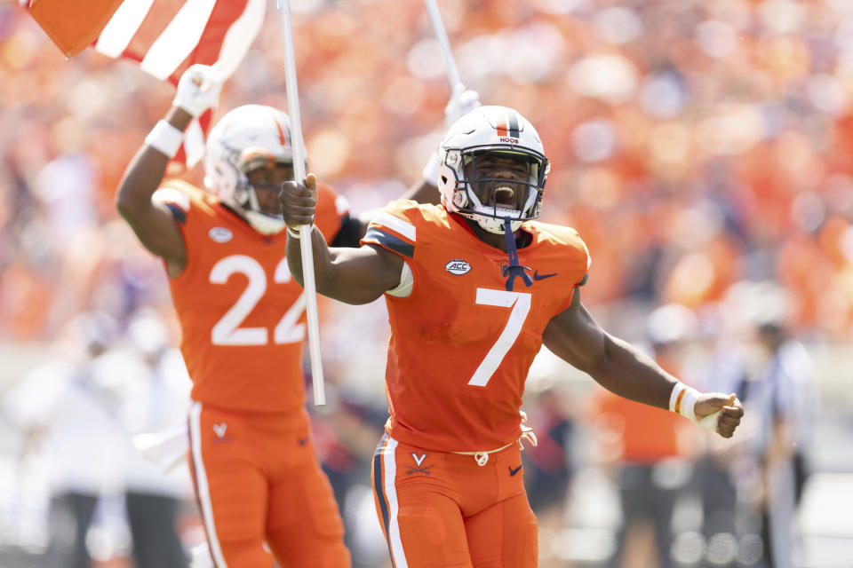 FILE - Virginia's running back Mike Hollins (7), who survived a shooting that left three of his teammates dead, runs out on the field before an NCAA college football game against James Madison in Charlottesville, Va., Saturday, Sept. 9, 2023. Hollins is one of three recipients of college football’s Comeback Player of the Year Award announced Monday, Dec. 18. (AP Photo/Mike Kropf, File)