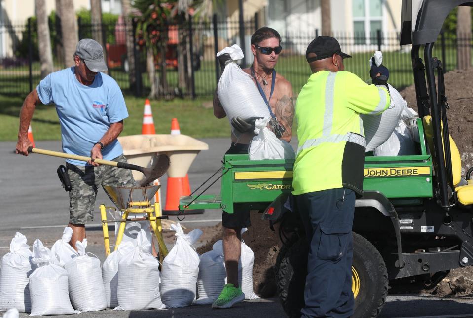 Travis and his dad Tony Allen fill sandbags at Bethune Point Park as a Daytona Beach public works employee loads the bags onto a utility vehicle on Monday, Aug. 28, 2023. Preparations continue while tropical storm Idalia approaches and gains hurricane strength.